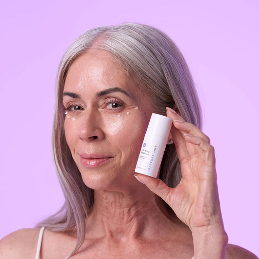 Mature woman holding the anti-aging face cream
